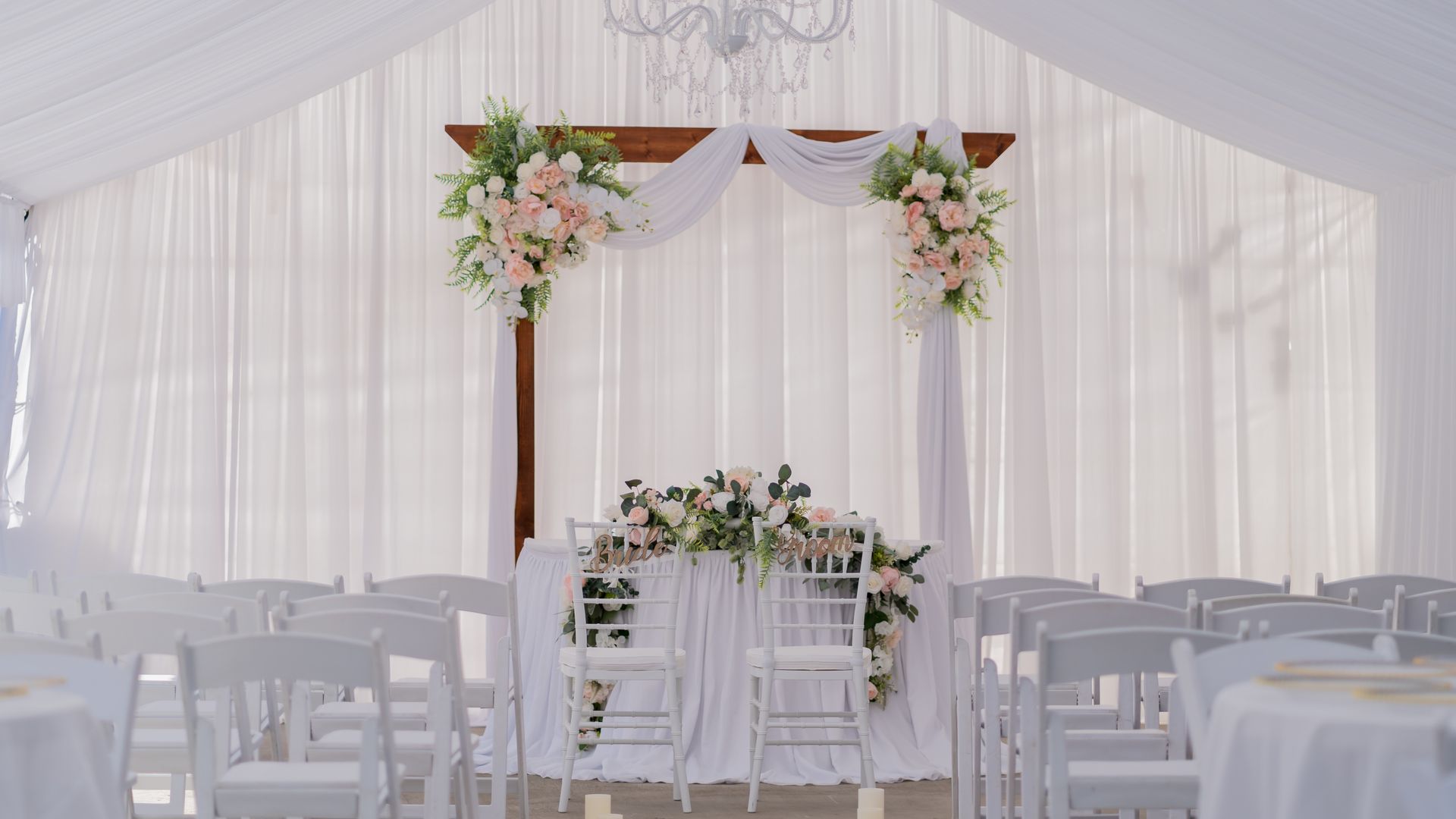 Intimate wedding ceremony at The Tiny Chateau, a warm event venue with exposed white brick and elegant decor in Jacksonville, NC