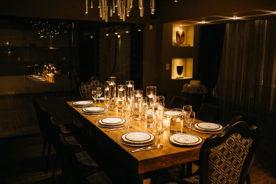 Luxurious reception table setting with candles and chandeliers