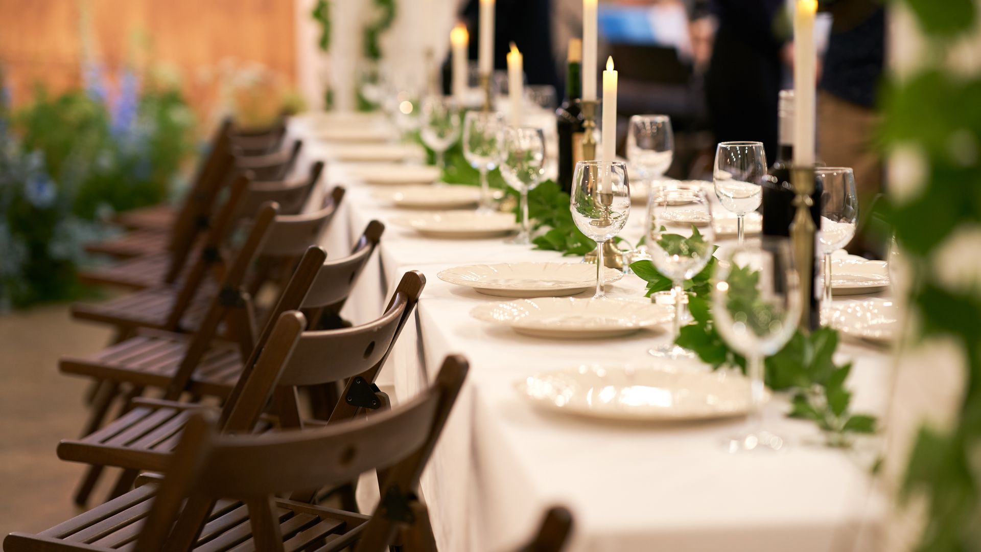 Interior of The Tiny Chateau event venue featuring exposed white brick, hardwood floors, and warm lighting in Jacksonville, NC